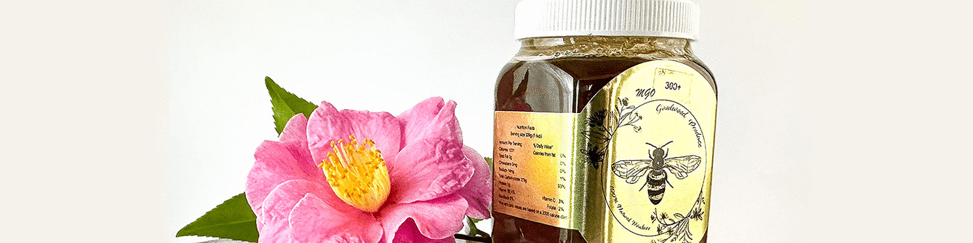 MGO 300+ Honey next to a flower