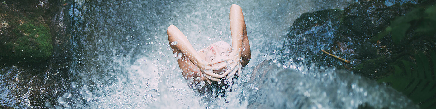 Lady showering in a waterfall photo by Seth Doyle