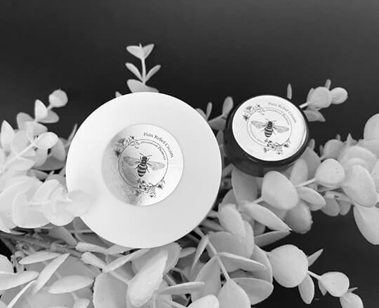 A 50g & 10g jars of MGO Honey & Camel milk pain cream with CBD oil in it.