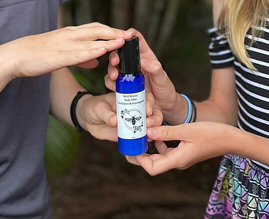 Two people holding Goodwood Produce's MGO Honey Body mist