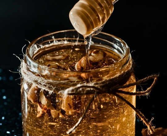 Jar of honey with dark background